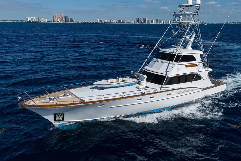  Yacht Photos Pics 1985 Feadship Yacht Fisherman cruising on open sea with city skyline in background.