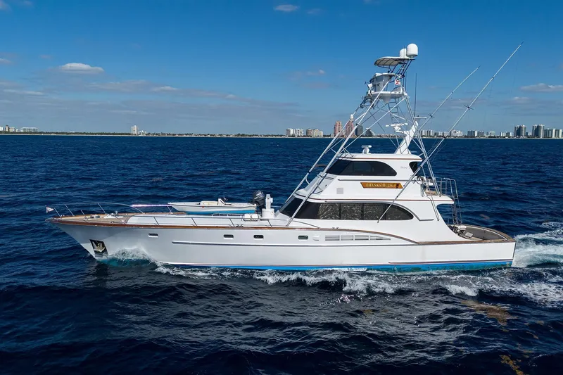  Yacht Photos Pics 1985 Feadship Yacht Fisherman cruising on open sea under clear blue sky.