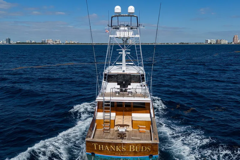  Yacht Photos Pics 1985 Feadship Yacht Fisherman cruising on open sea with city skyline in background.