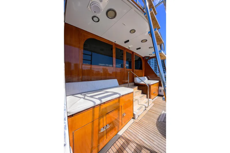  Yacht Photos Pics 1985 Feadship Yacht Fisherman deck with wooden finish and cushioned seating.