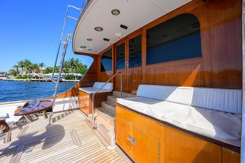  Yacht Photos Pics 1985 Feadship Yacht Fisherman deck with wooden finish, seating, and ocean view.