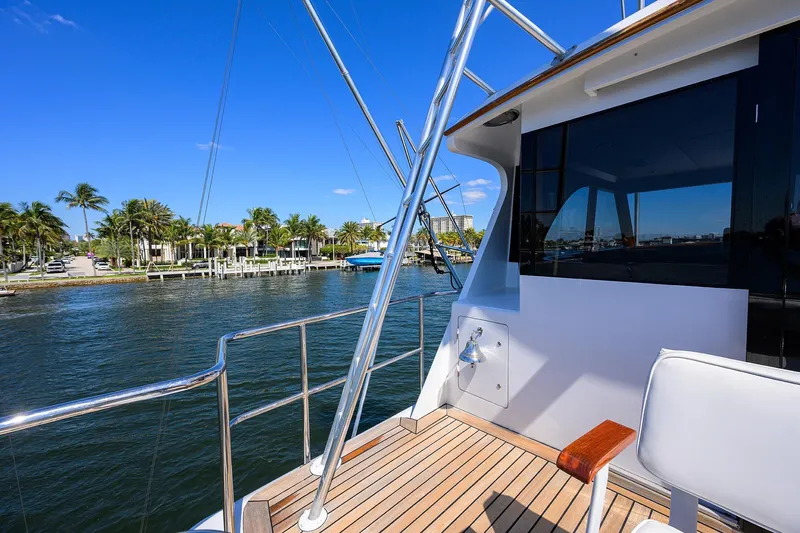  Yacht Photos Pics 1985 Feadship Yacht Fisherman deck with waterfront view and palm trees.