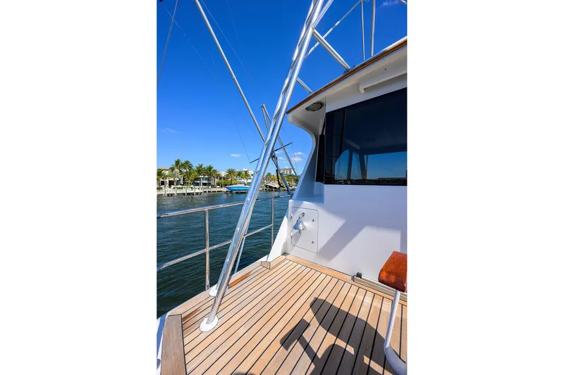 Yacht Photos Pics 1985 Feadship Yacht Fisherman deck with railing, blue sky, and waterfront view.