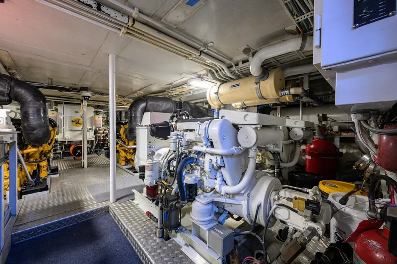  Yacht Photos Pics Engine room of a 1985 Feadship Yacht Fisherman, showcasing machinery and equipment.