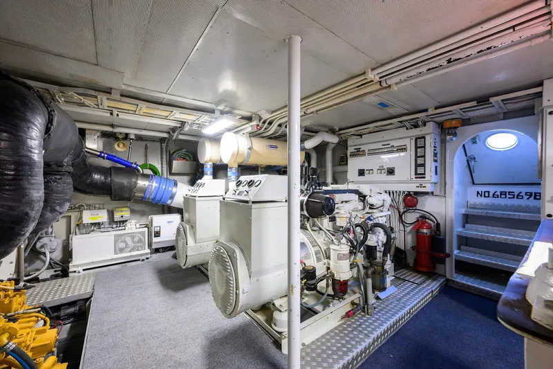  Yacht Photos Pics Engine room of a 1985 Feadship Yacht Fisherman, featuring machinery and equipment.