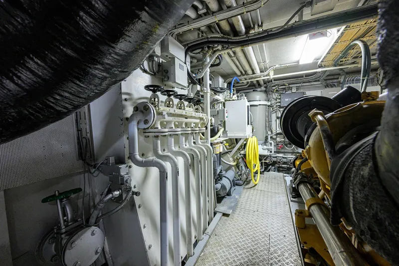  Yacht Photos Pics Engine room of 1985 Feadship Yacht Fisherman, showcasing machinery and piping systems.