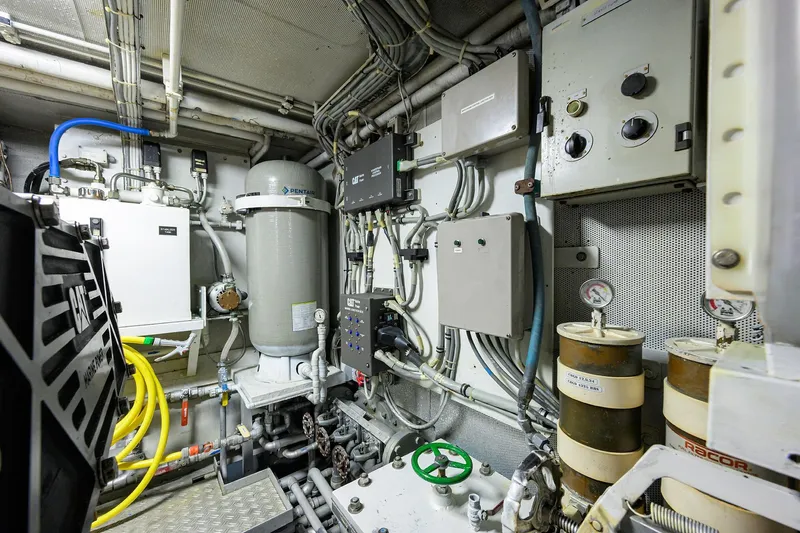  Yacht Photos Pics Engine room of 1985 Feadship Yacht Fisherman, featuring complex machinery and control panels.