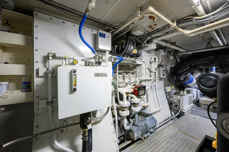  Yacht Photos Pics Engine room of 1985 Feadship Yacht Fisherman with complex piping and machinery.