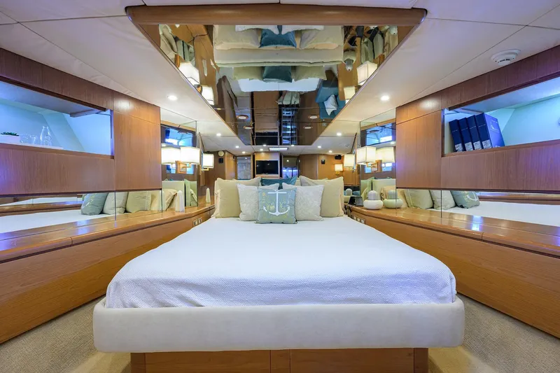  Yacht Photos Pics Luxurious 1985 Feadship Yacht Fisherman bedroom with elegant wood paneling and mirrored ceiling.
