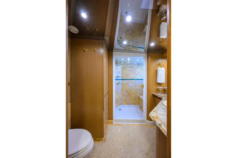  Yacht Photos Pics Luxurious bathroom on 1985 Feadship Yacht Fisherman with marble accents and modern fixtures.
