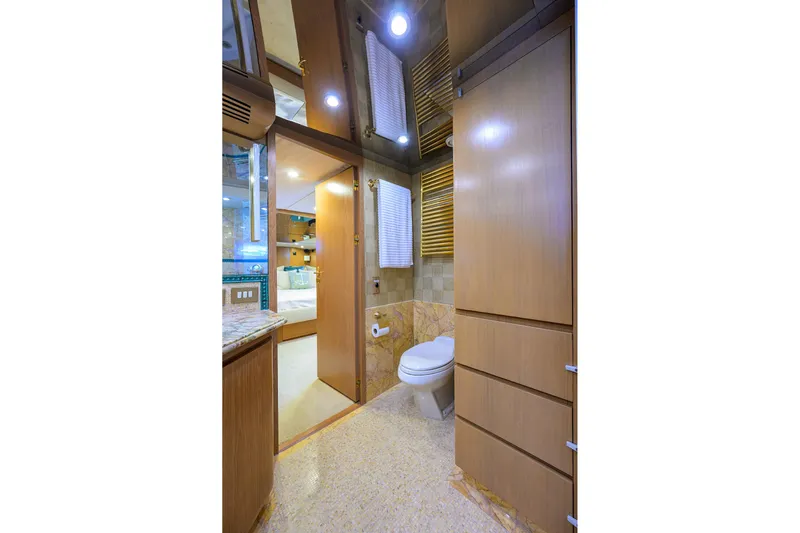 Yacht Photos Pics Luxurious bathroom interior on 1985 Feadship Yacht Fisherman, featuring wood cabinetry and modern fixtures.
