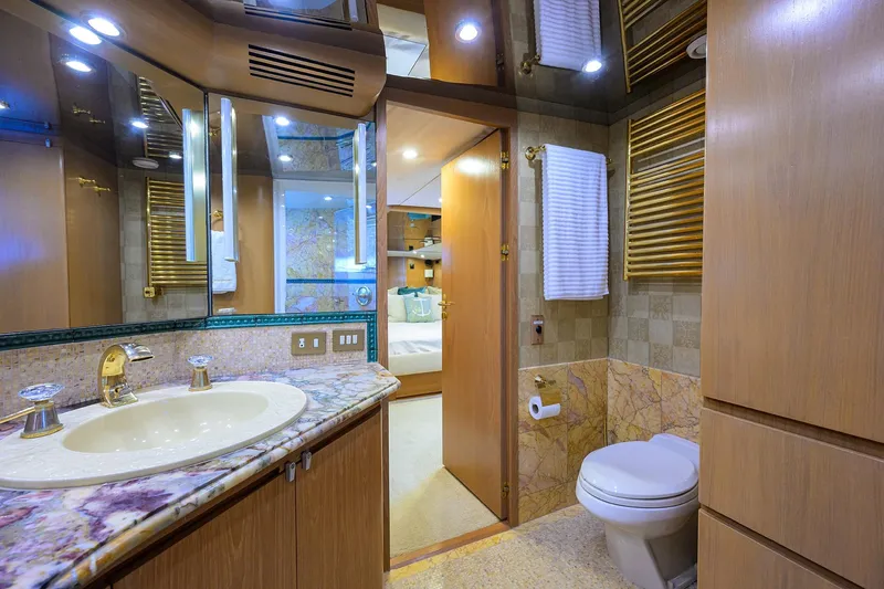  Yacht Photos Pics Luxurious bathroom on 1985 Feadship Yacht Fisherman with marble countertop and elegant fixtures.