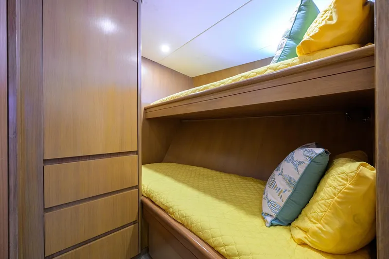  Yacht Photos Pics Cozy cabin with bunk beds on 1985 Feadship Yacht Fisherman, featuring yellow bedding and wooden interior.