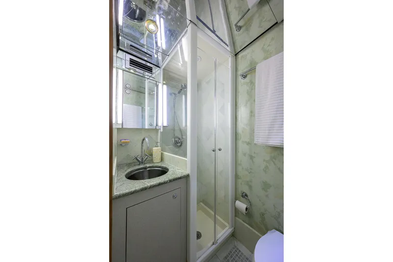  Yacht Photos Pics Luxurious bathroom in 1985 Feadship Yacht Fisherman, featuring shower and sink.