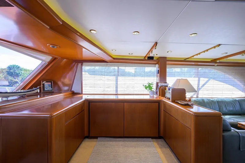  Yacht Photos Pics Luxurious interior of 1985 Feadship Yacht Fisherman with wood paneling and large windows.