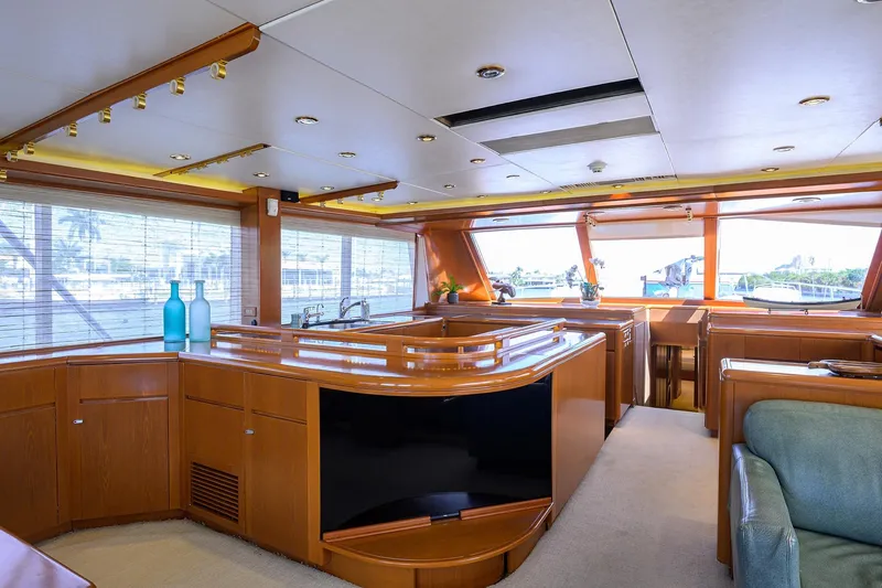  Yacht Photos Pics Luxurious 1985 Feadship Yacht Fisherman interior with elegant wood finishes and panoramic windows.