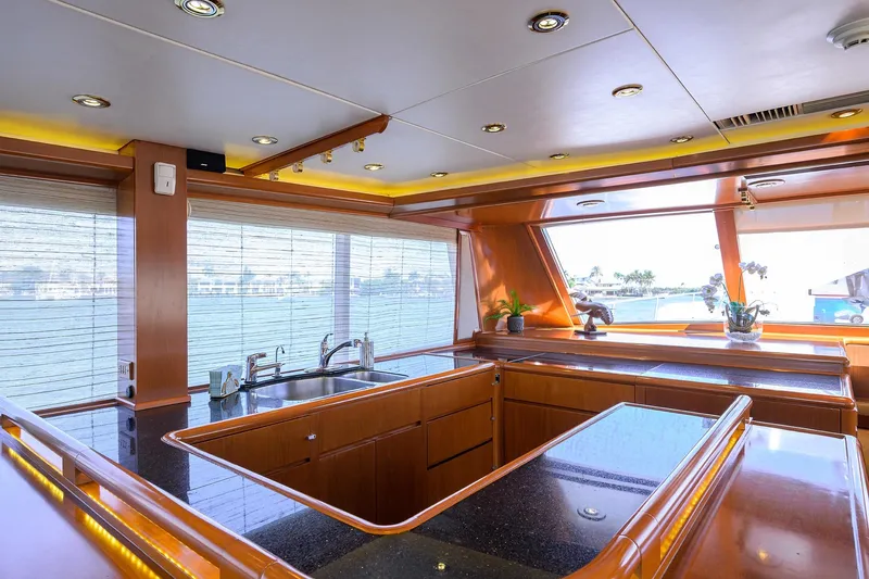  Yacht Photos Pics Luxurious 1985 Feadship Yacht Fisherman kitchen with sleek wood and modern fixtures.