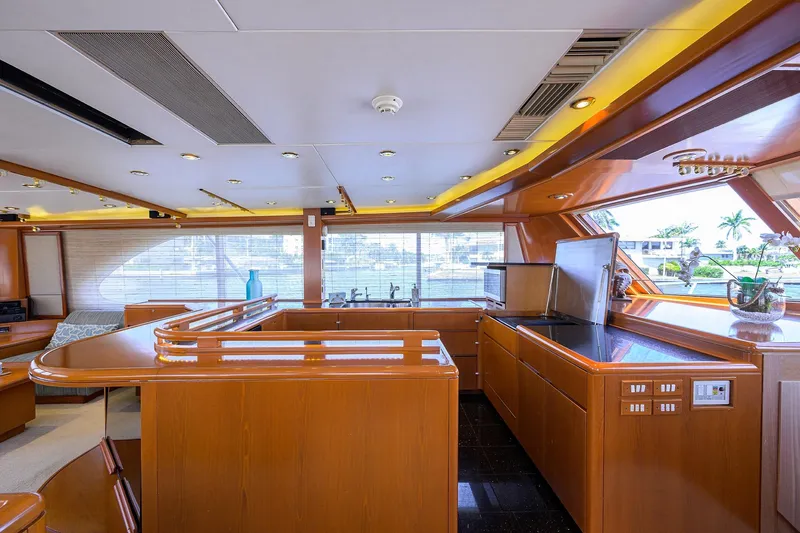  Yacht Photos Pics Luxurious 1985 Feadship Yacht Fisherman interior with modern kitchen and elegant wood finishes.