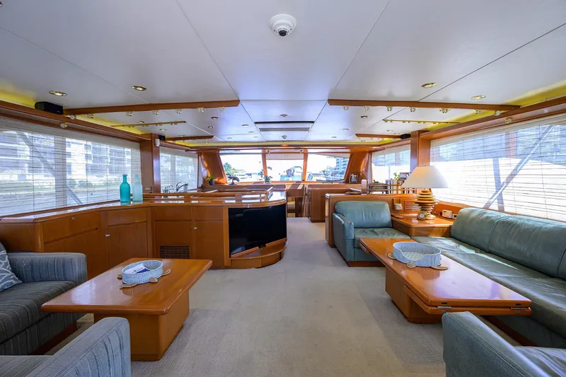  Yacht Photos Pics Luxurious interior of 1985 Feadship Yacht Fisherman with elegant wood furnishings and plush seating.