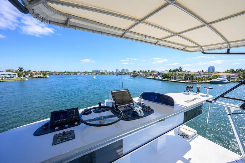  Yacht Photos Pics Helm of 1985 Feadship Yacht Fisherman overlooking scenic waterfront view.