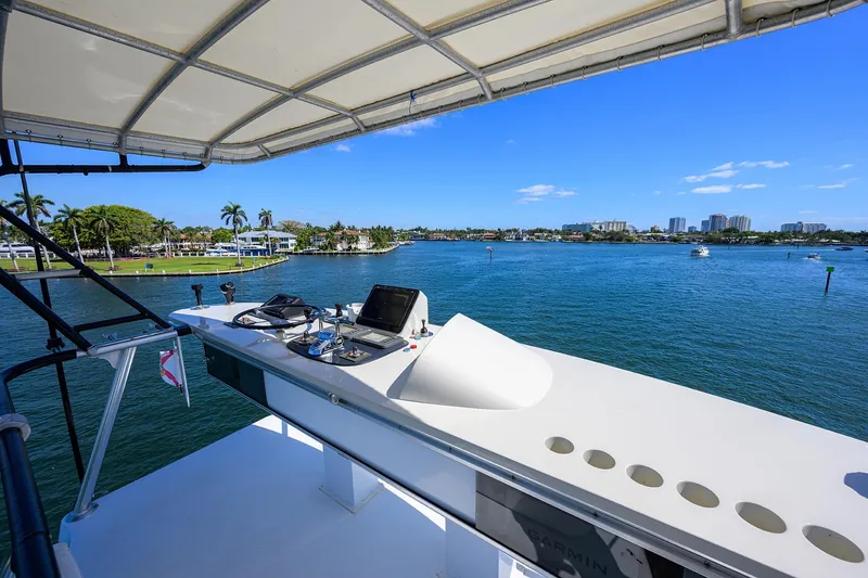  Yacht Photos Pics 1985 Feadship Yacht Fisherman helm with scenic waterfront view, clear skies, and palm trees.