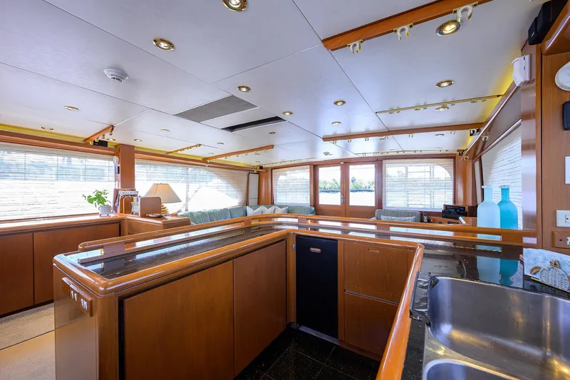  Yacht Photos Pics Luxurious interior of 1985 Feadship Yacht Fisherman with modern kitchen and elegant decor.