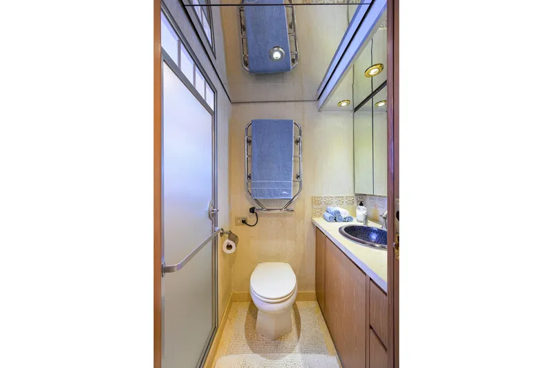  Yacht Photos Pics Luxurious bathroom on 1985 Feadship Yacht Fisherman with modern fixtures and elegant design.
