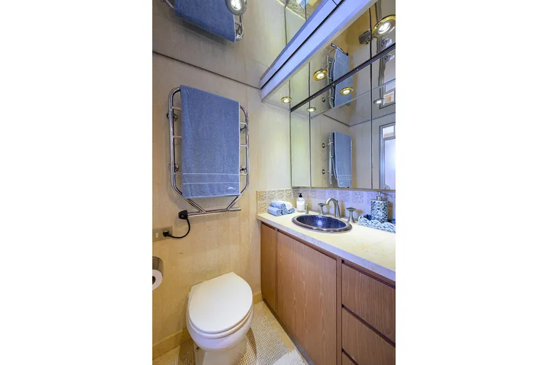  Yacht Photos Pics Luxurious bathroom in 1985 Feadship Yacht Fisherman, featuring elegant fixtures and mirrored cabinetry.