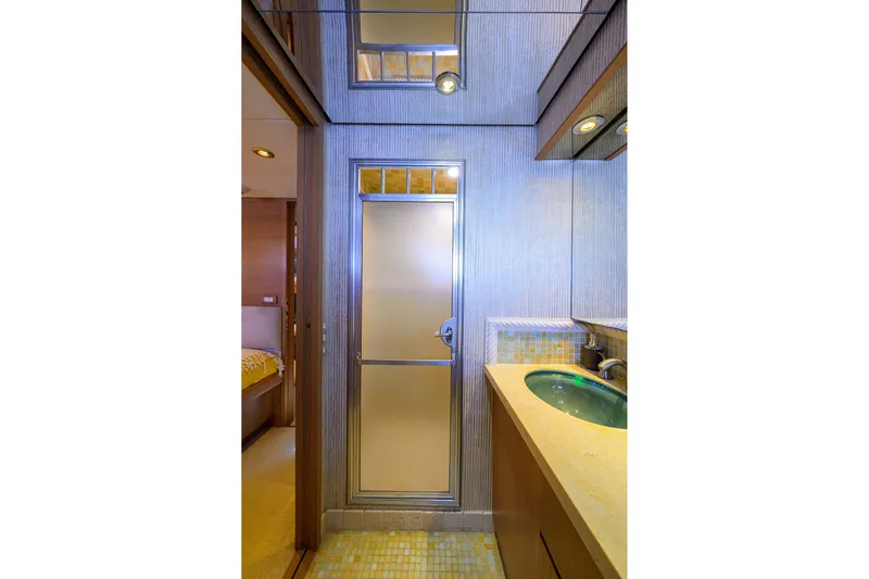  Yacht Photos Pics Bathroom interior of 1985 Feadship Yacht Fisherman, featuring modern fixtures and a sleek design.