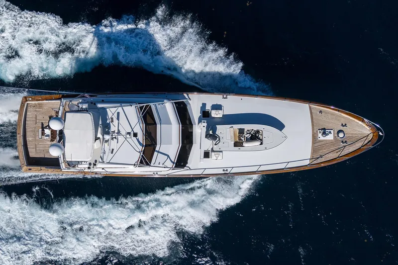  Yacht Photos Pics Aerial view of 1985 Feadship Yacht Fisherman cruising on open water.