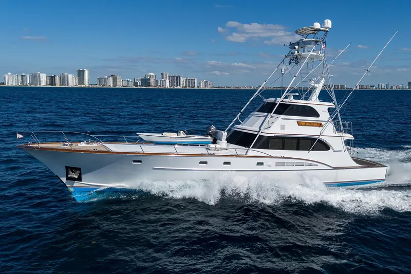  Yacht Photos Pics 1985 Feadship Yacht Fisherman cruising on ocean near city skyline.
