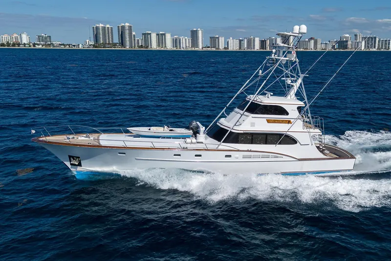  Yacht Photos Pics 1985 Feadship Yacht Fisherman cruising on ocean with city skyline in background.