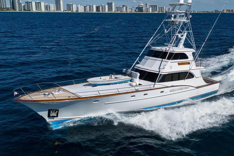  Yacht Photos Pics 1985 Feadship Yacht Fisherman cruising on ocean near city skyline.