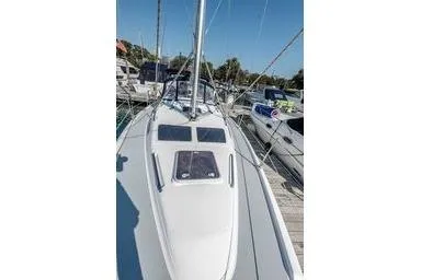 2003 Hunter 356 sailboat docked at marina under clear blue sky.