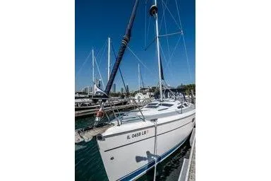2003 Hunter 356 sailboat docked at marina under clear blue sky.