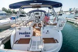 2003 Hunter 356 sailboat docked, featuring "Pharma Sea" name and American flag.