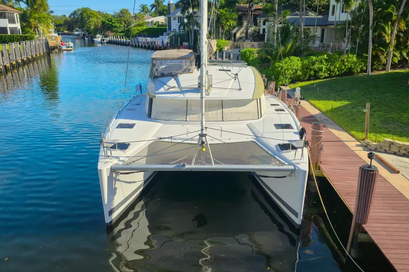 Waterlilly Yacht Photos Pics 2017 Fountaine Pajot Lucia 40 catamaran docked in a scenic canal setting.