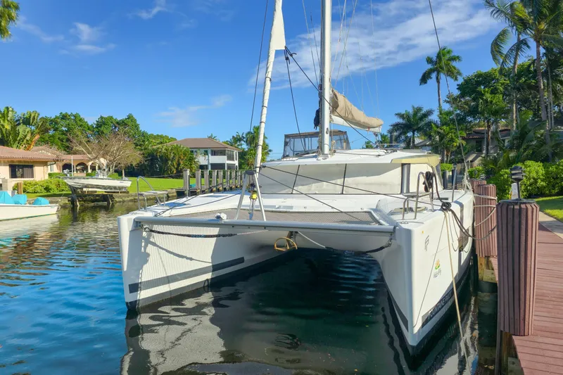 Waterlilly Yacht Photos Pics 2017 Fountaine Pajot Lucia 40 catamaran docked in a tropical marina setting.