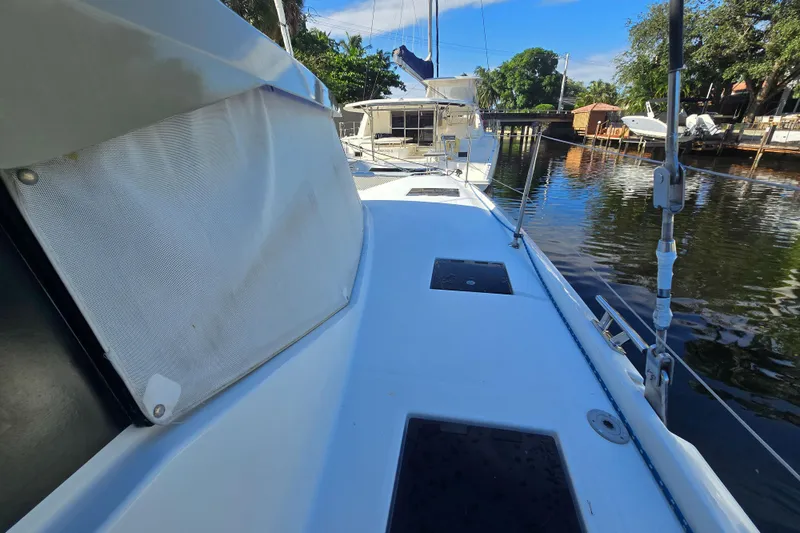 Waterlilly Yacht Photos Pics 2017 Fountaine Pajot Lucia 40 catamaran docked by a serene waterfront.