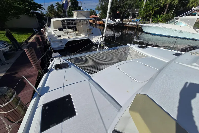 Waterlilly Yacht Photos Pics 2017 Fountaine Pajot Lucia 40 catamaran docked, showcasing spacious deck and netting.