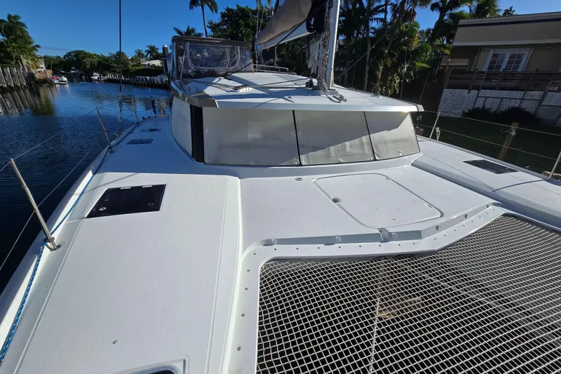 Waterlilly Yacht Photos Pics 2017 Fountaine Pajot Lucia 40 catamaran docked, showcasing sleek deck design and netting.