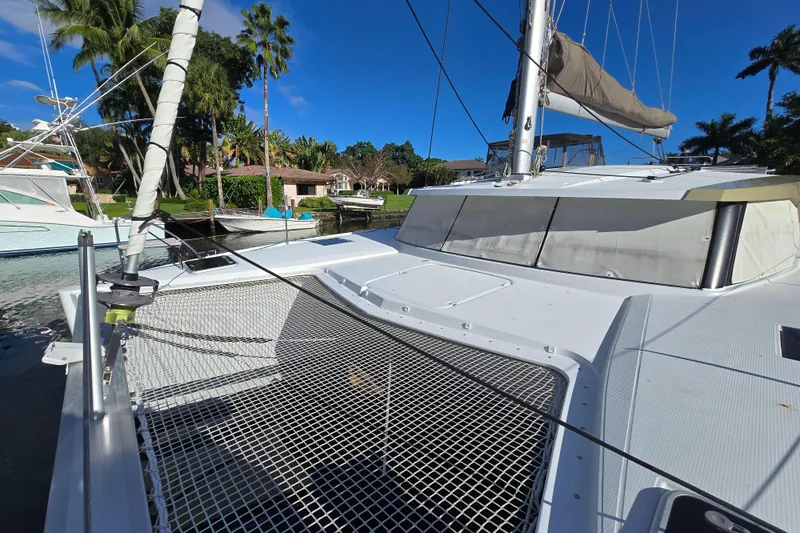 Waterlilly Yacht Photos Pics 2017 Fountaine Pajot Lucia 40 catamaran docked, featuring spacious deck and netting.