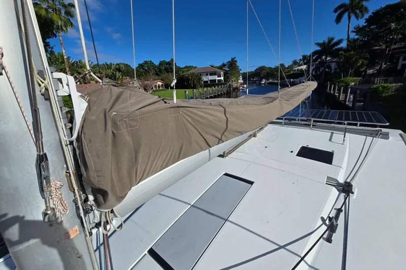 Waterlilly Yacht Photos Pics 2017 Fountaine Pajot Lucia 40 catamaran deck with covered sail, docked in a scenic canal.