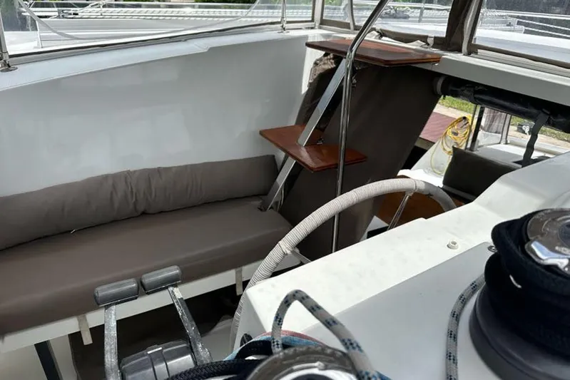 Waterlilly Yacht Photos Pics Interior view of 2017 Fountaine Pajot Lucia 40 catamaran cockpit with seating and steering wheel.