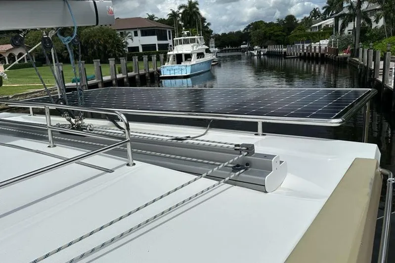 Waterlilly Yacht Photos Pics 2017 Fountaine Pajot Lucia 40 catamaran with solar panels docked in a scenic canal.