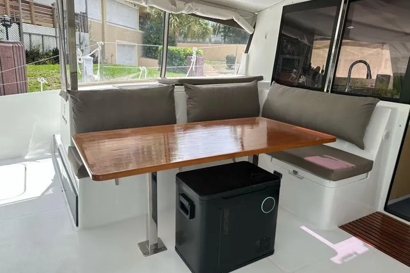 Waterlilly Yacht Photos Pics 2017 Fountaine Pajot Lucia 40 catamaran interior with dining area and cushioned seating.