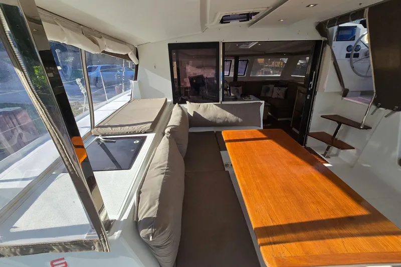 Waterlilly Yacht Photos Pics Interior of 2017 Fountaine Pajot Lucia 40 catamaran with seating and wooden table.