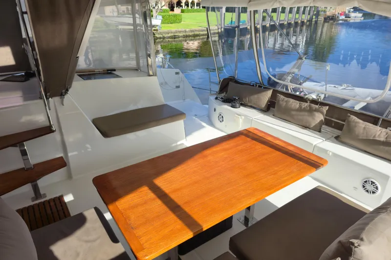 Waterlilly Yacht Photos Pics Spacious deck of 2017 Fountaine Pajot Lucia 40 catamaran with seating and wooden table.