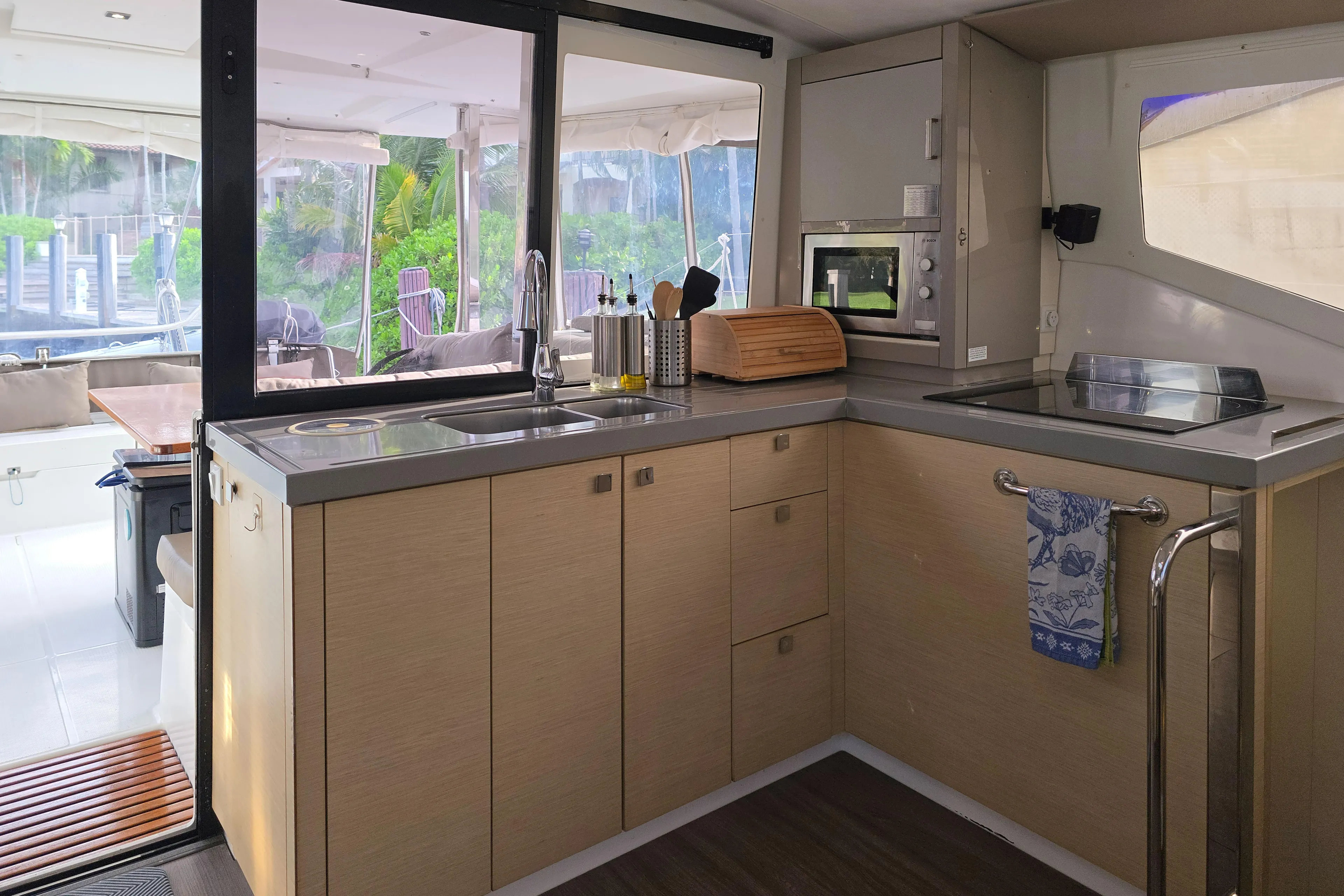 Waterlilly Yacht Photos Pics Modern kitchen interior of 2017 Fountaine Pajot Lucia 40 catamaran, featuring sleek cabinetry and appliances.