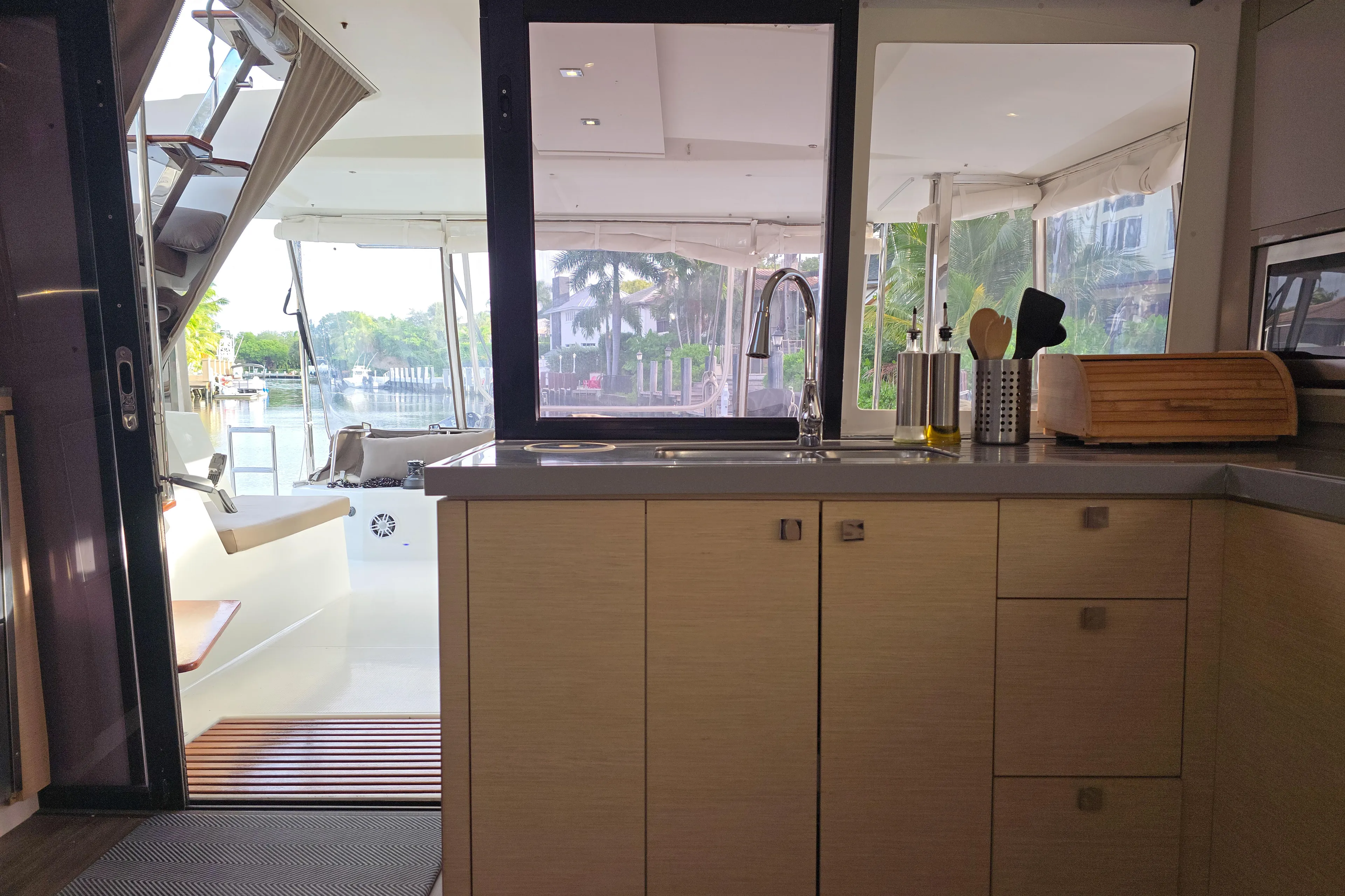 Waterlilly Yacht Photos Pics Interior view of 2017 Fountaine Pajot Lucia 40 catamaran kitchen and outdoor seating area.